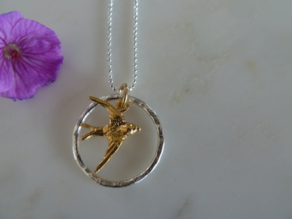 silver circle & gold swallow pendant