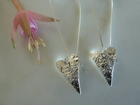 slender silver heart charm earrings on long ear wire